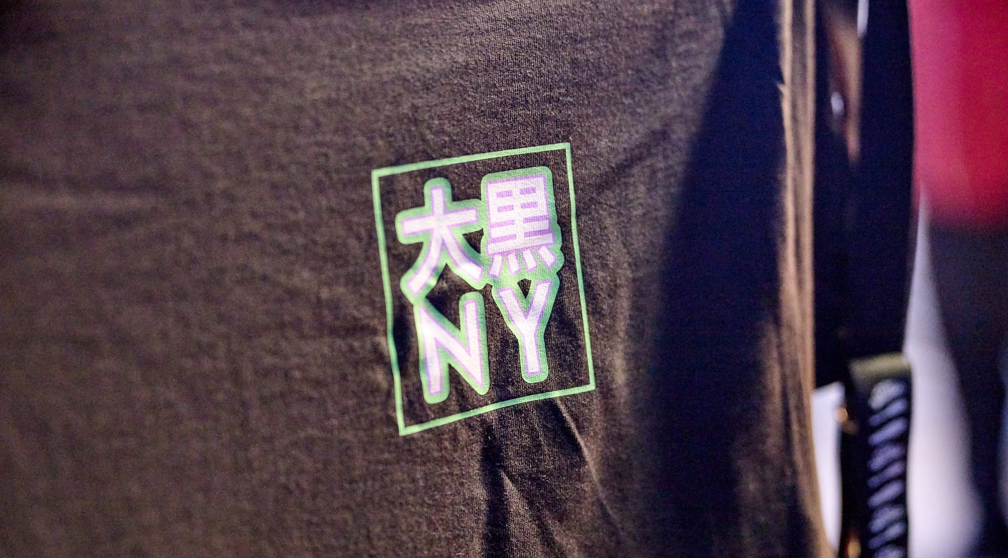 The box logo on a member's crewneck at Chinatown Night Out. Applied by a print shop working from the spec sheet, with no involvement from me